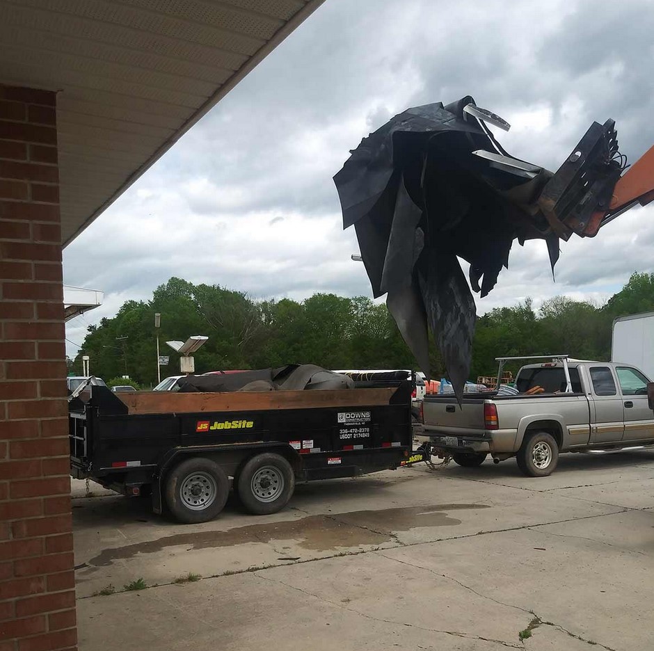 Moving away the ripped off roof to replace it