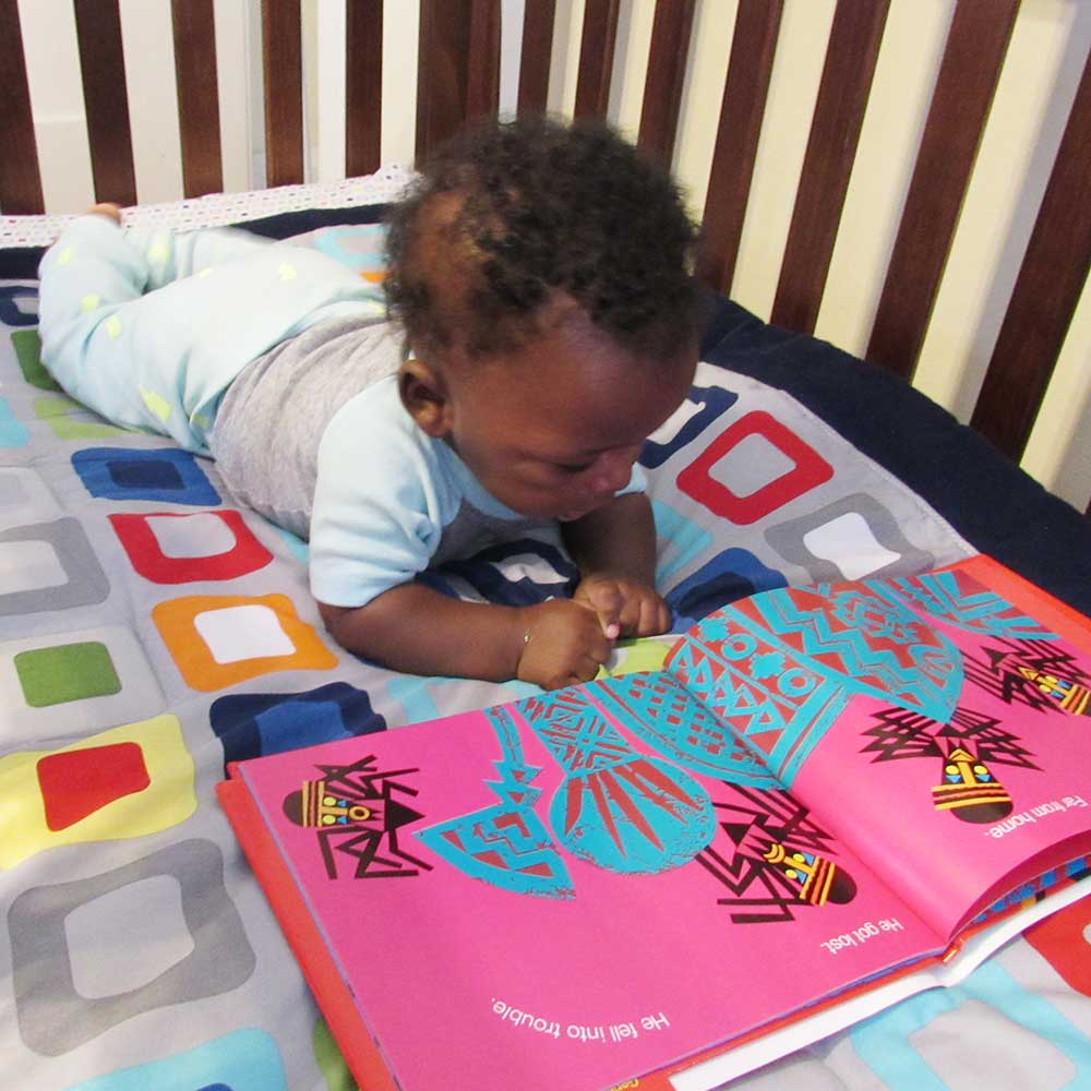 Anansi reading a children's book, where his name comes from