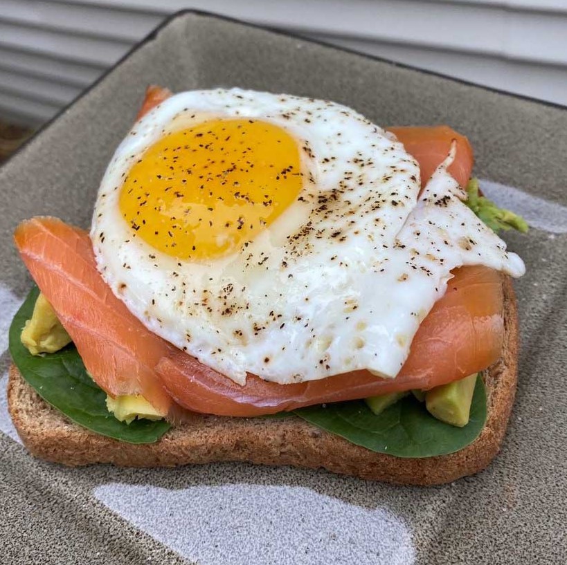 Avocado toast with salmon and an egg