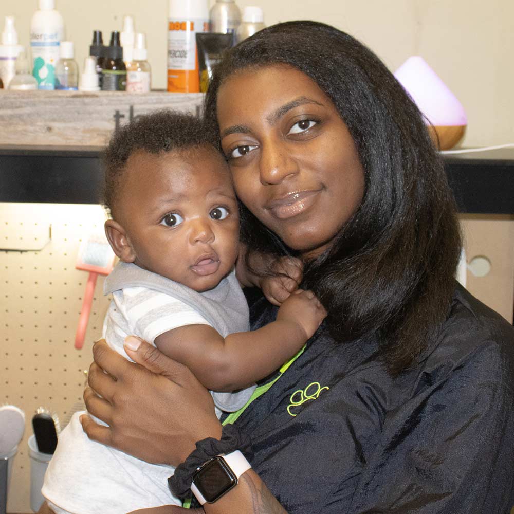 Groomer Deja Pearson and her son Anansi at her Grooming Salon