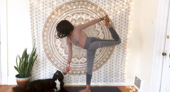 Groomer & Yogi Deja Pearson does standing bow pulling pose with her dog