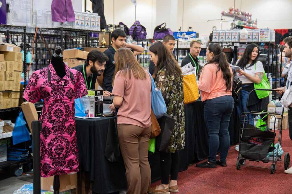 Groomers checking out at a vendor booth at Groom Expo West in 2020